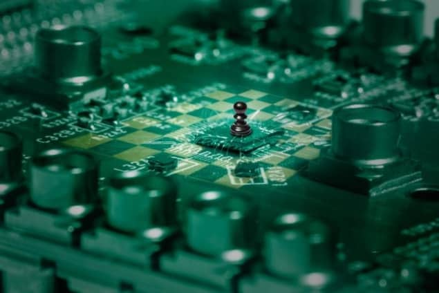 Photograph of the quantum chip hosting the 16-quantum-dot crossbar array, seamlessly integrated into a chessboard motif.