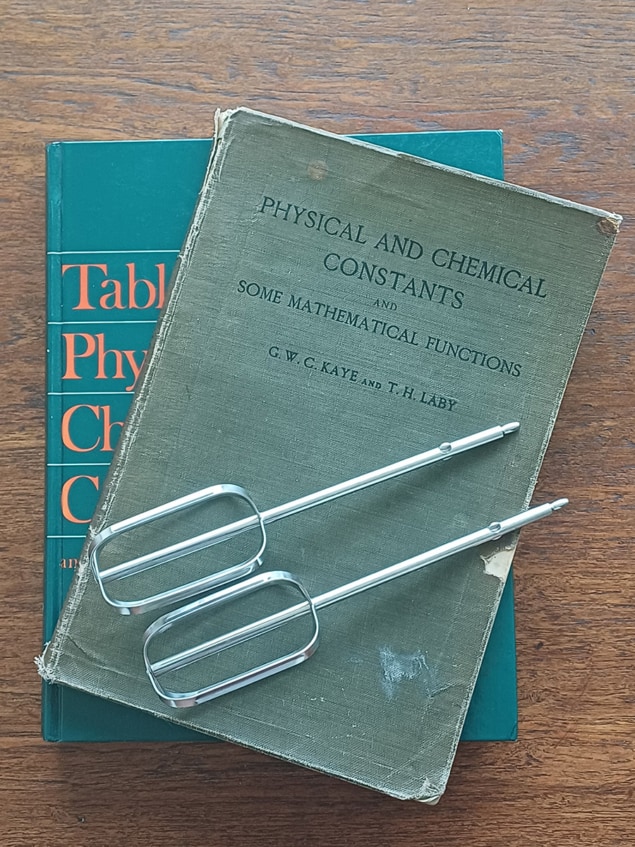 Two physics textbooks and two metal whisks