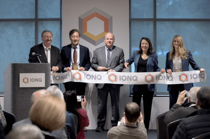 IonQ formally opens its Seattle facility, with IonQ CEO Peter Chapman at center and Sen. Maria Cantwell standing next to Chapman. (IonQ)